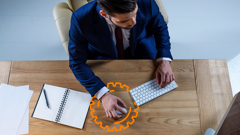 Artworked overhead view of businessman working at computer in office