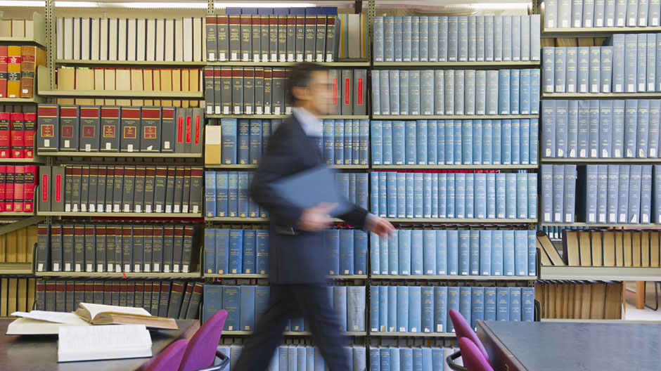 Hispanic businessman doing research in library
